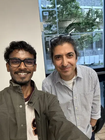 Vasu with a founder he met, both smiling at the camera.