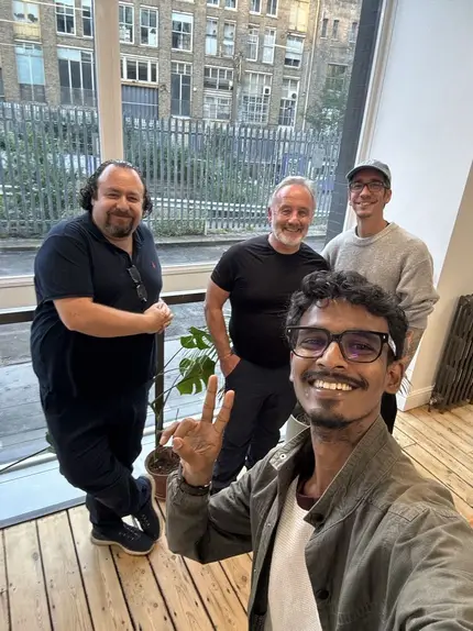 Vasu with a small group on an office terrace.