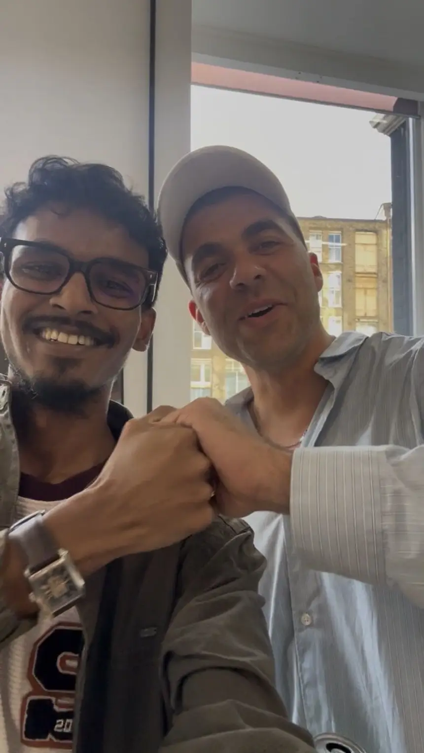 Vasu bumping fists with someone he has just met.