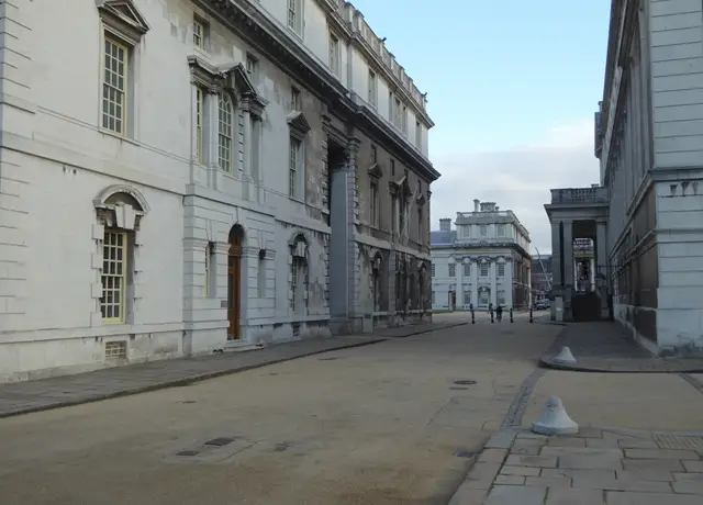 A paved way running between the Portland stone blocks of the Old Royal Naval College at Greenwich, the buildings the University of Greenwich teaches in at Maritime Greenwich