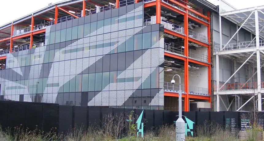 The Here East building at Queen Elizabeth Olympic Park during its conversion, with its orange steel frame and hoardings still up. Teesside University’s London campus is inside this complex, and no Teesside signage is visible in the picture