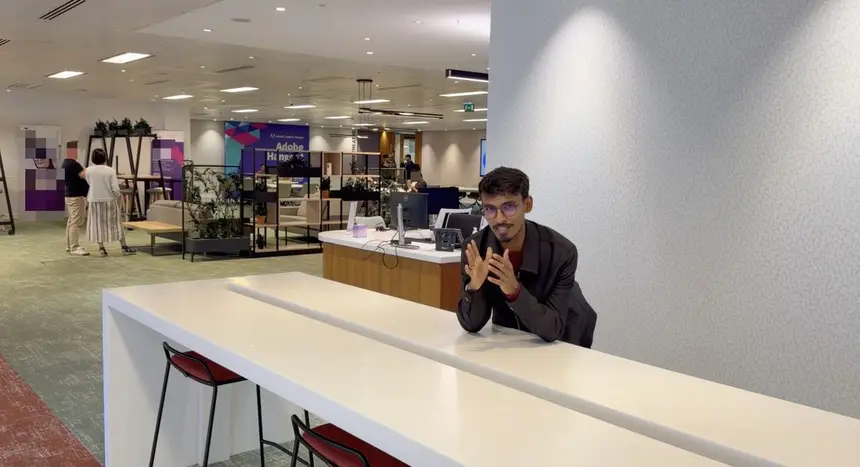 Vasu inside a university reception area.
